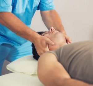 physiotherapist Working with Patient Neck